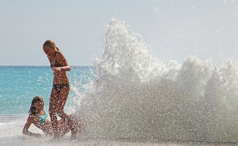 Girls playing in ocean waves