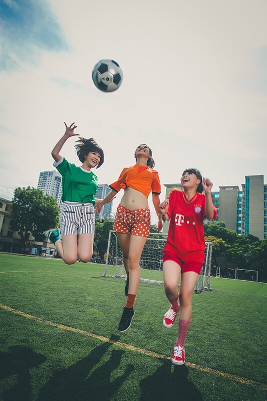 Girls playing soccer on a field