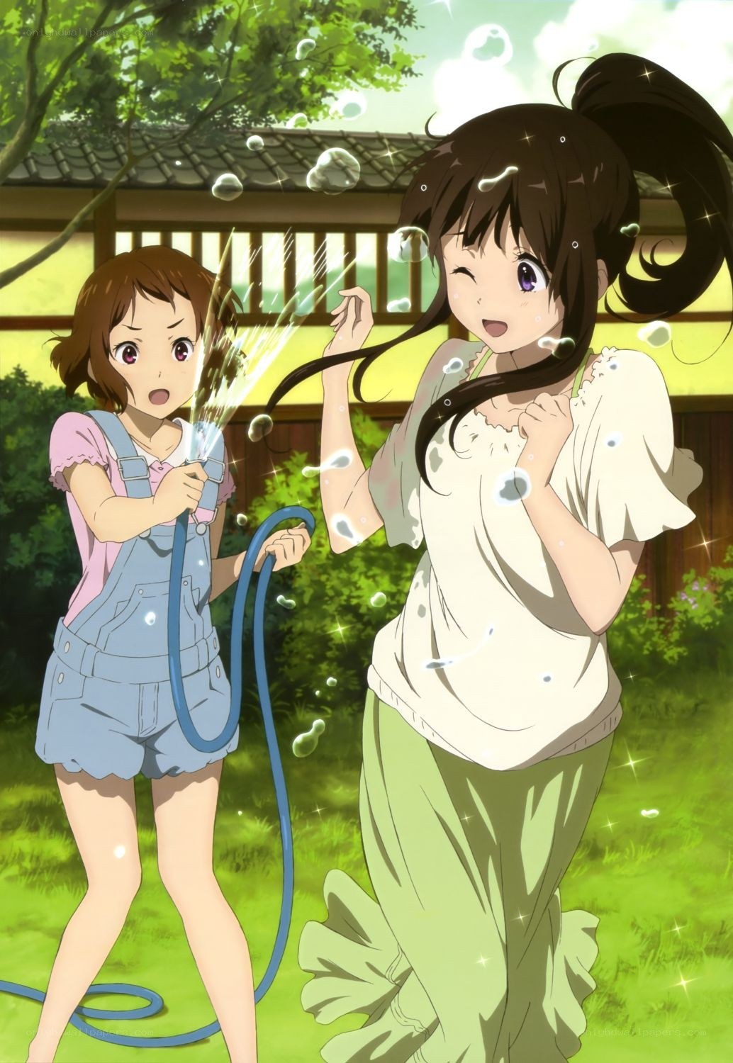 Girls playing with a hose