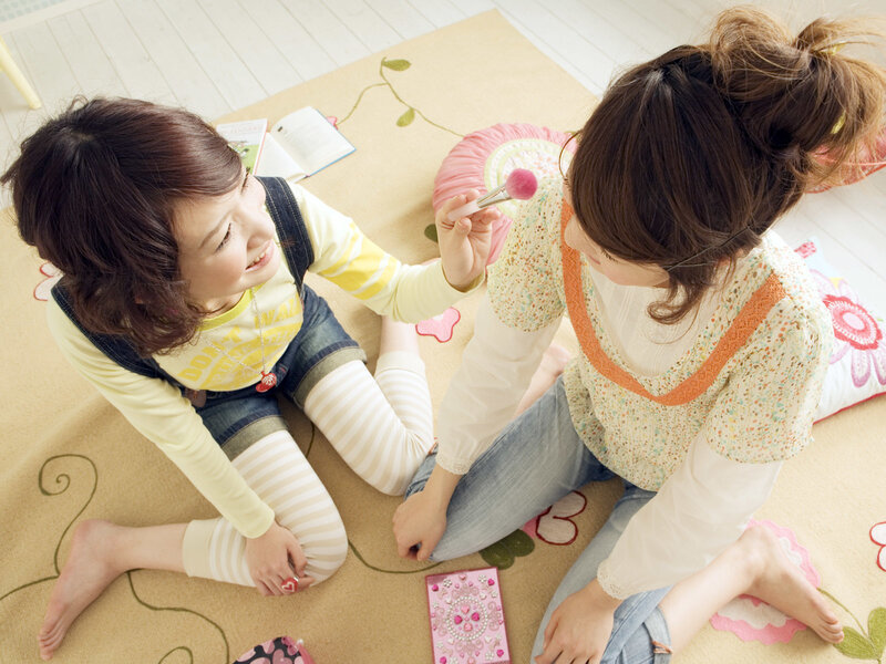 girls playing with makeup on floor