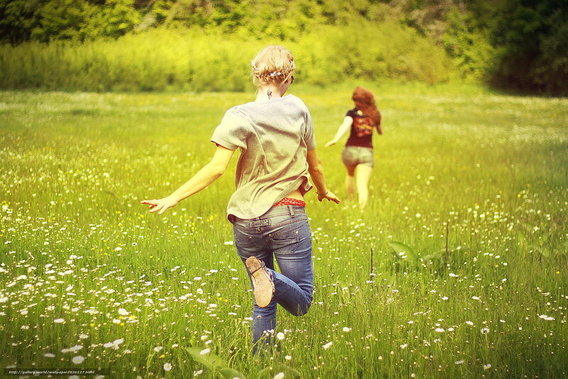 Girls running in a meadow
