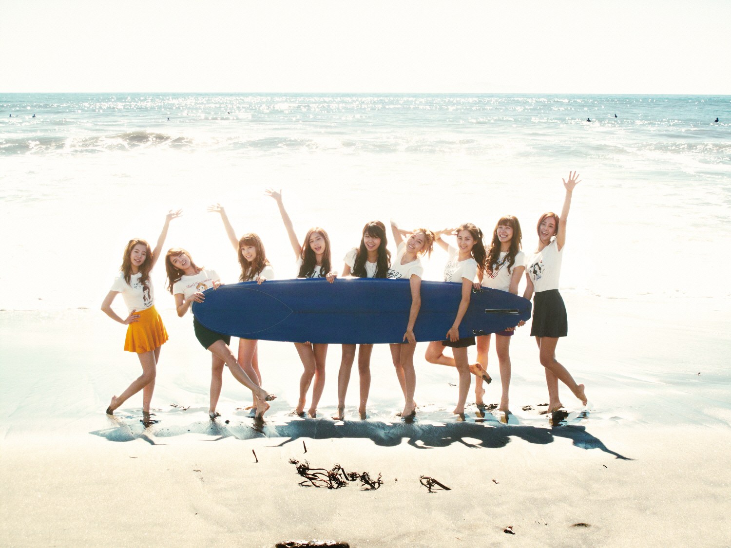 Girls with surfboard on beach