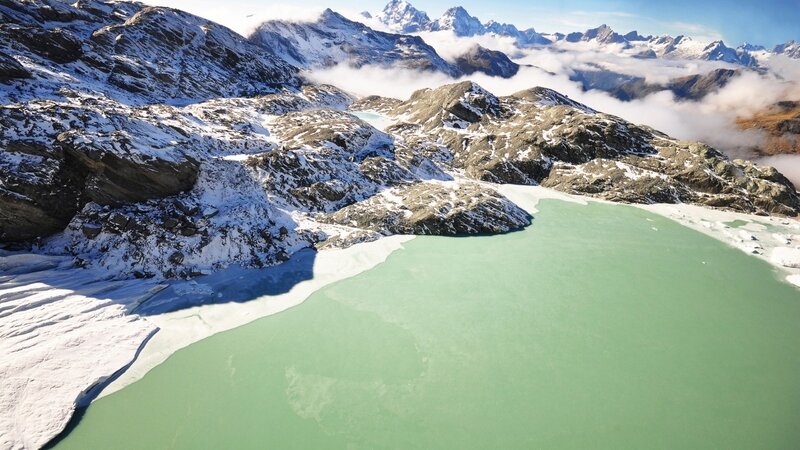 Glacial lake in snowy mountains