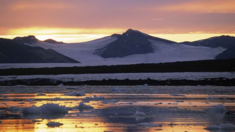 Glacier at sunset with ice floes