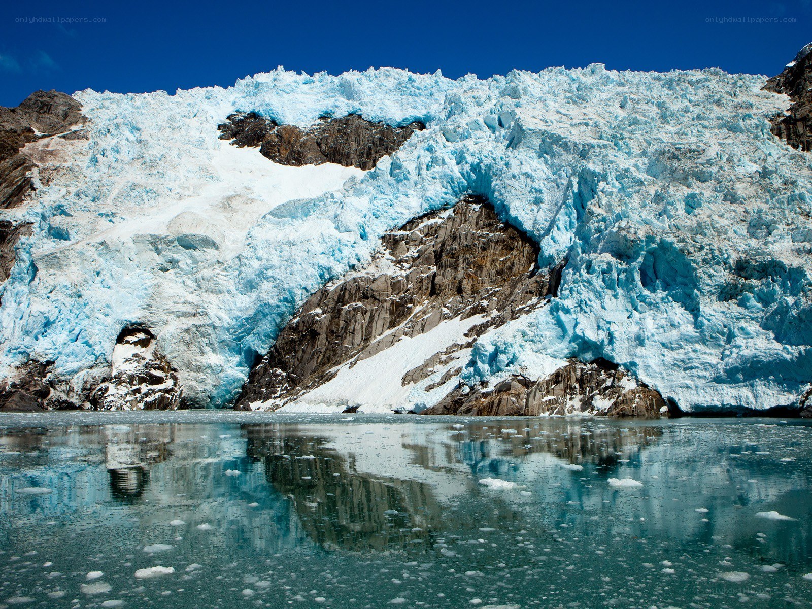 Glacier calving into calm water