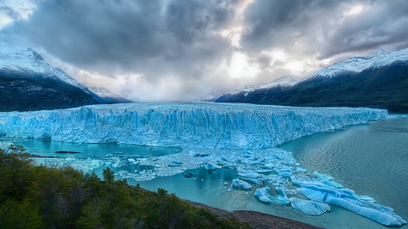 Glacier Calving into Lake — Blue, Dramatic, Afternoon, Photograph, Mountains, Icebergs