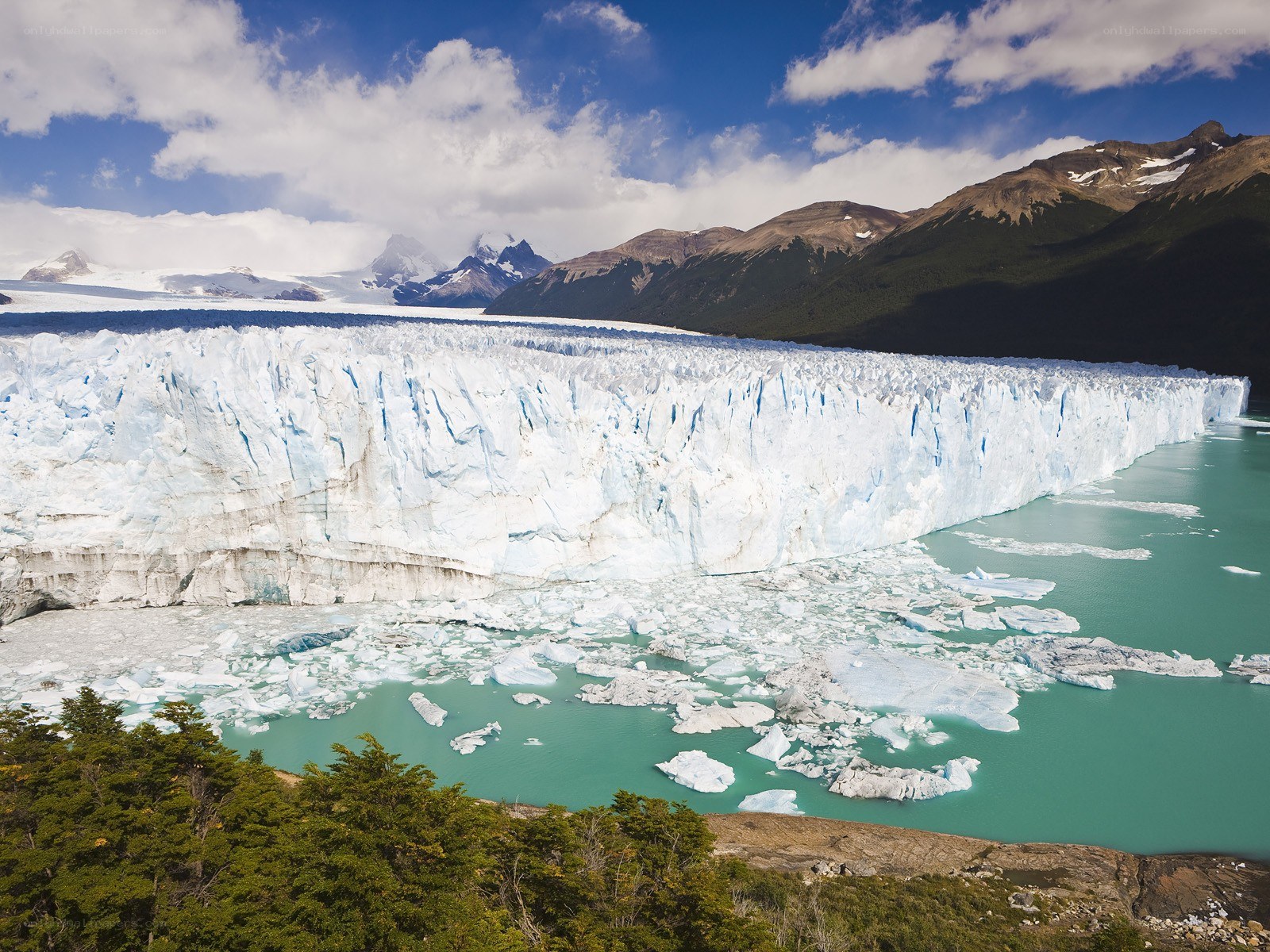 Glacier calving into turquoise lake
