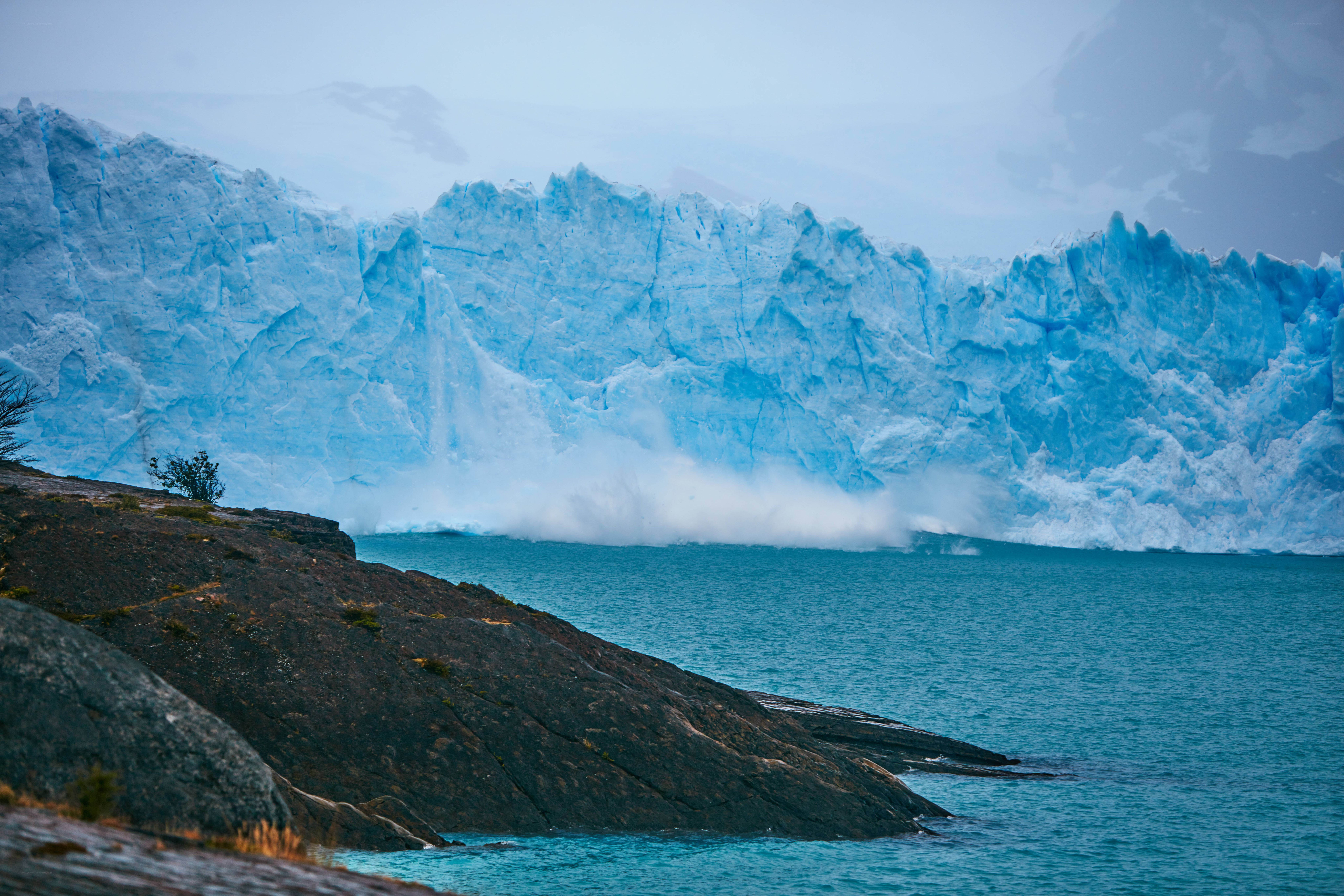 Glacier calving into turquoise water
