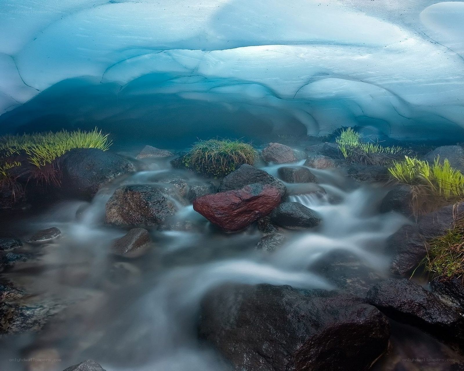 Glacier cave with flowing stream