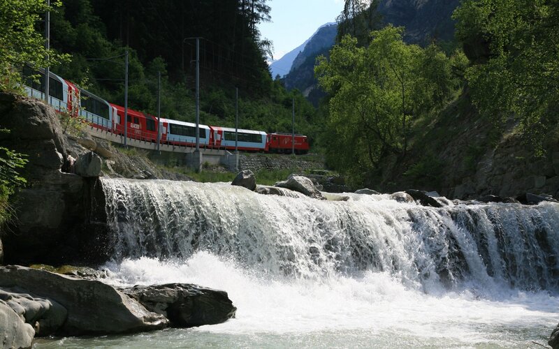 Glacier Express train by waterfall