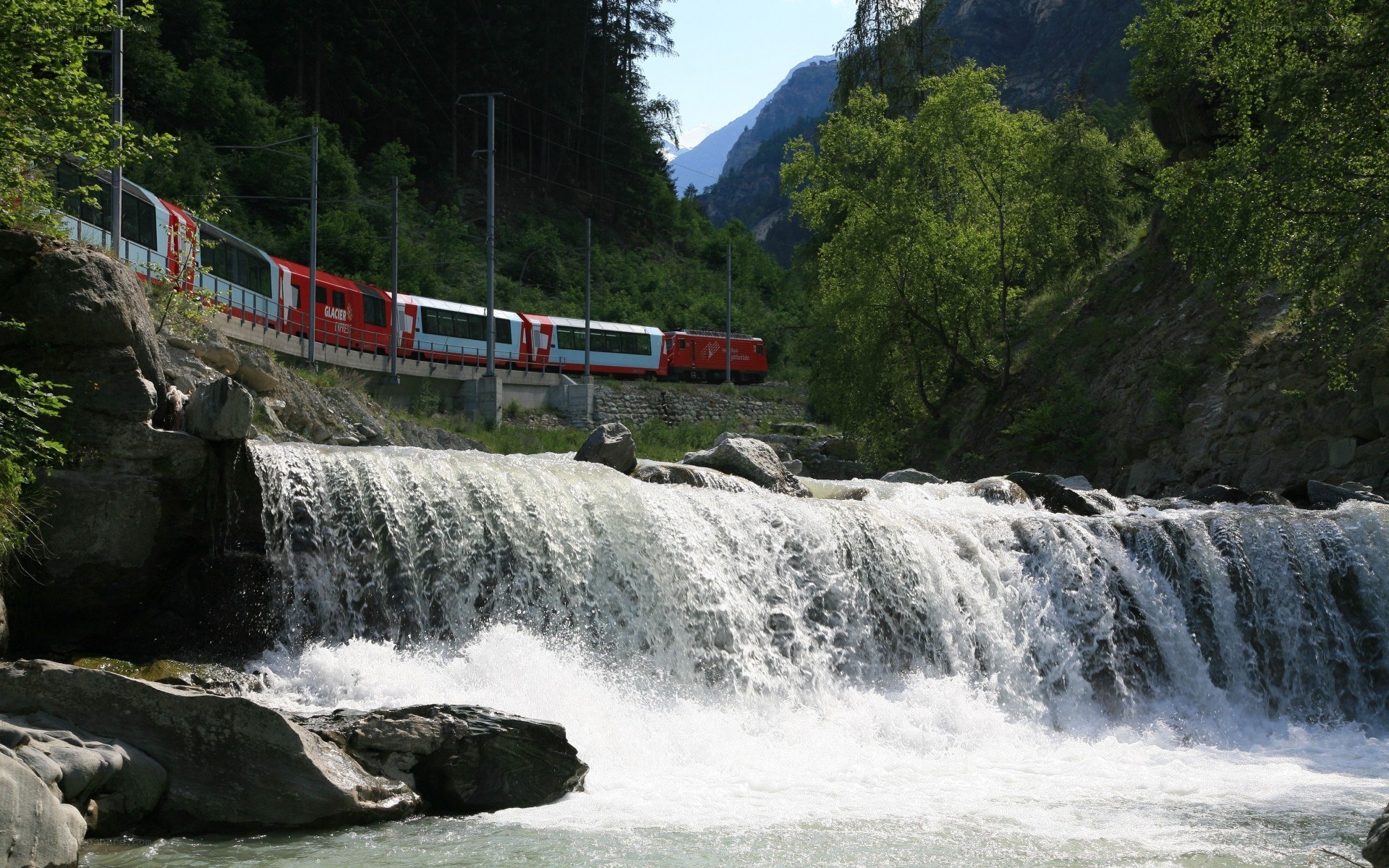 Glacier Express train by waterfall