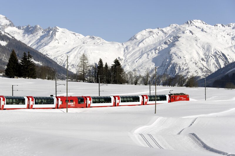 Glacier Express train in snowy mountains