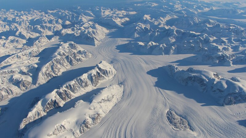 Glacier Flowing Through Mountains