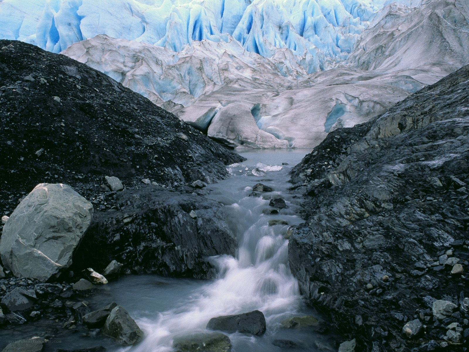 Glacier stream in rocky valley