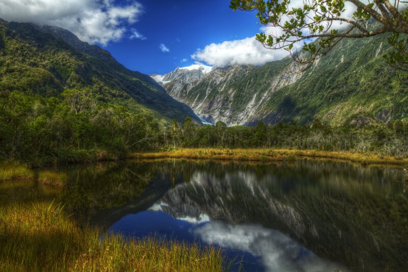 Glacier valley with lake reflection