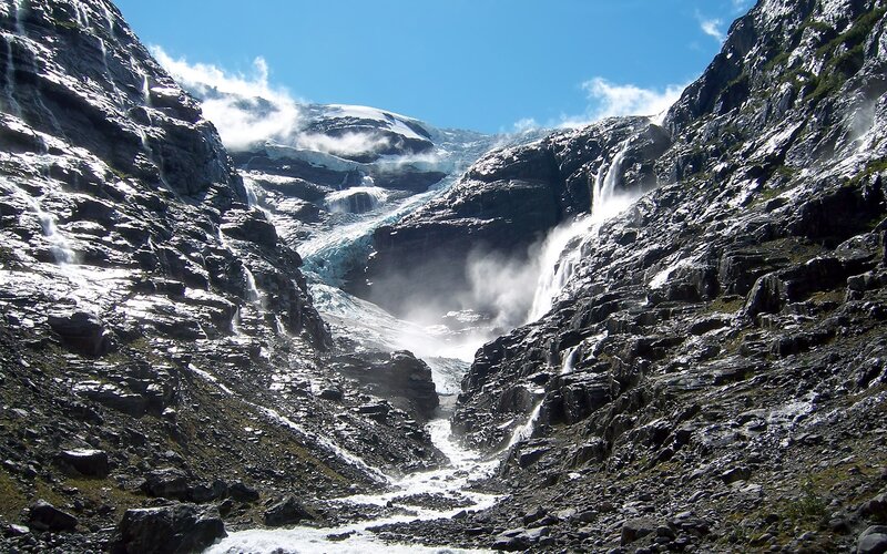 Glacier waterfall in mountain valley