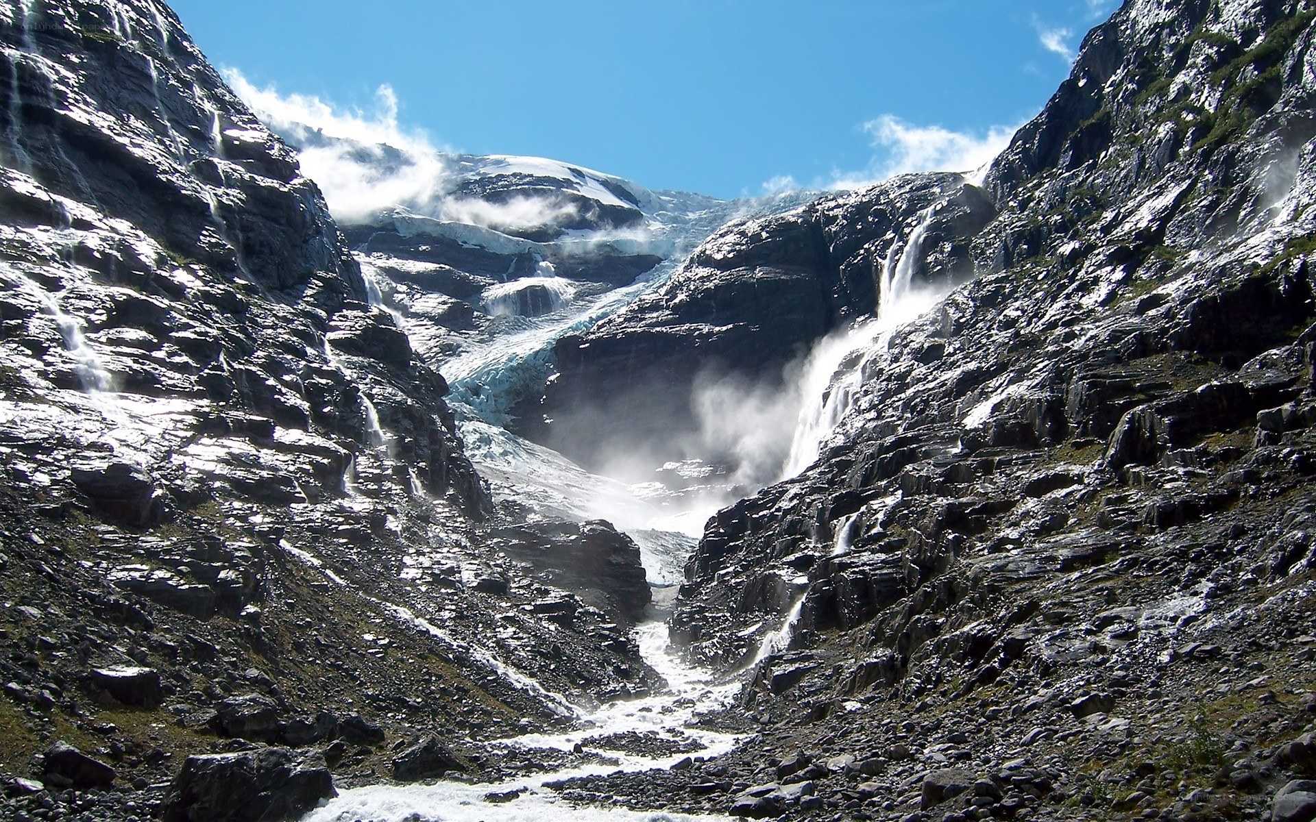 Glacier waterfall in mountain valley