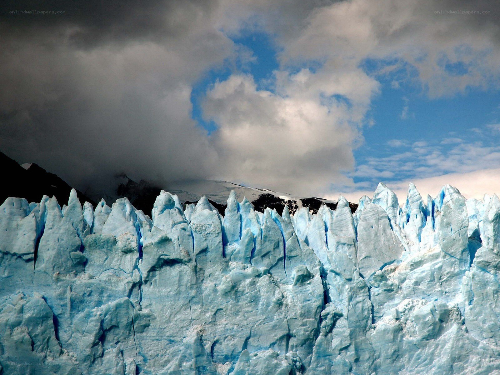 Glacier with blue ice and cloudy sky