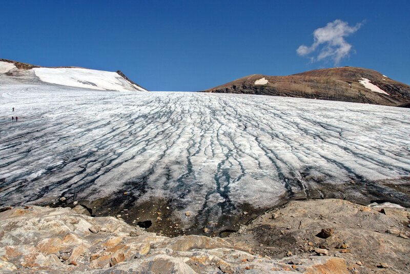 Glacier with crevasses and hikers