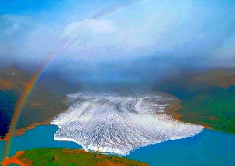 Glacier with rainbow arc