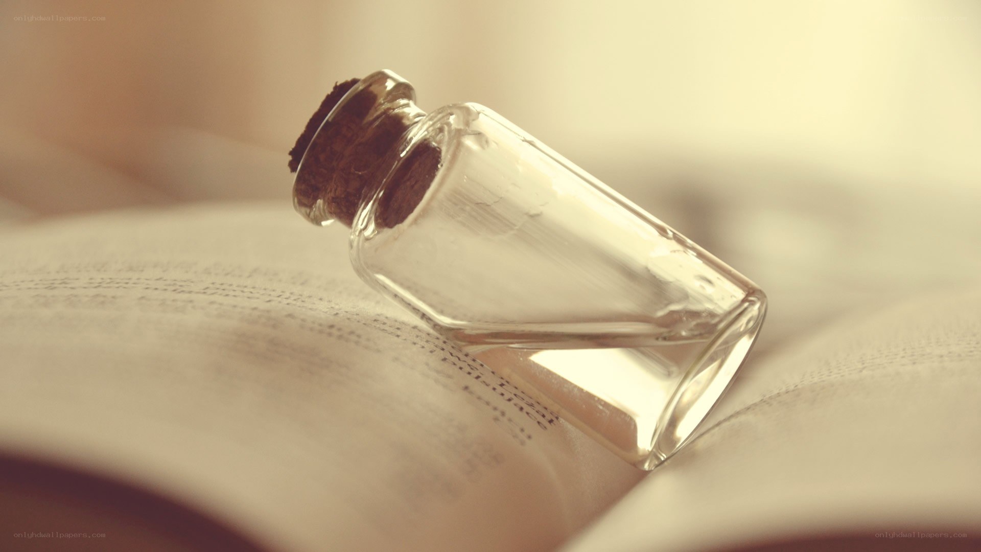 glass bottle on open book