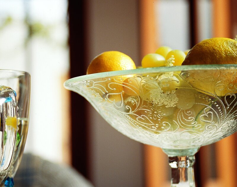 Glass bowl with lemons and grapes
