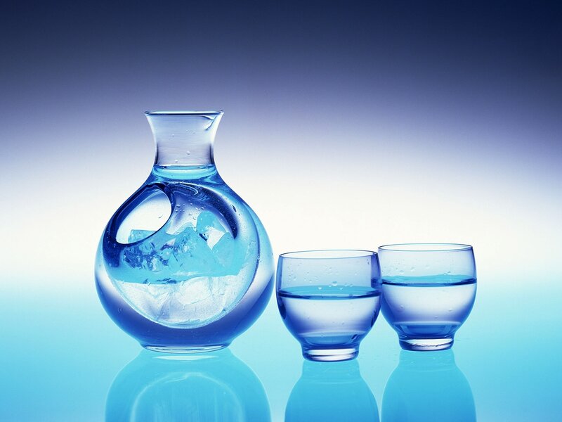 Glass carafe with ice and cups
