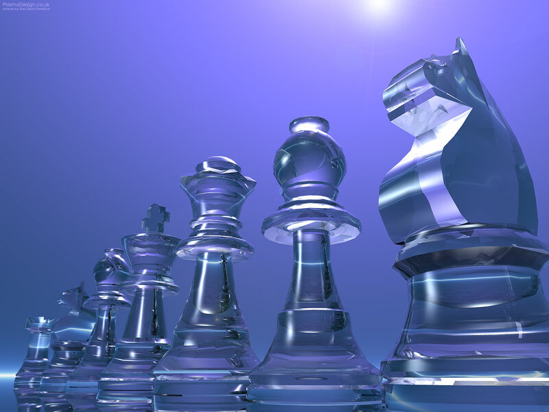 Glass chess pieces in blue light