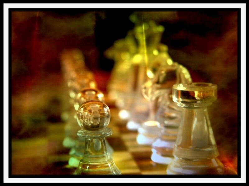 Glass chess pieces on board