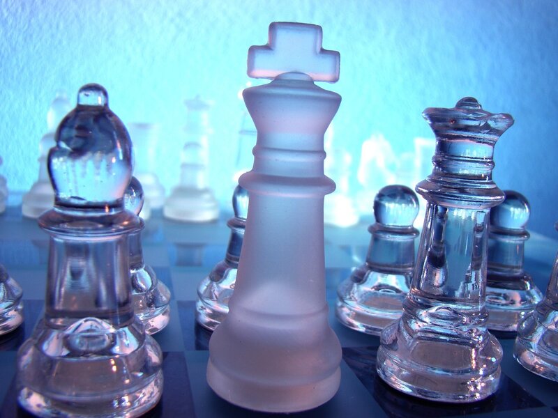 Glass chess pieces on board