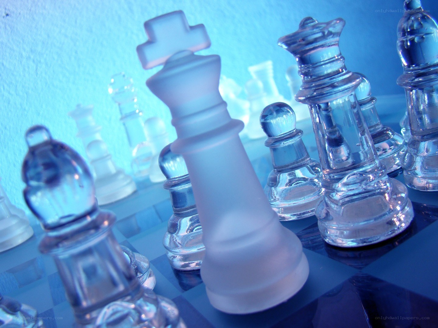 Glass chess pieces on board