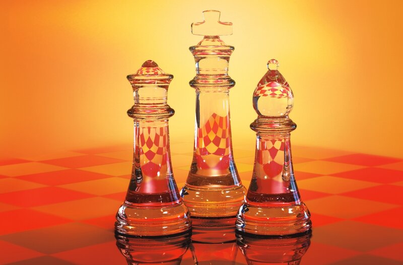 Glass chess pieces on board