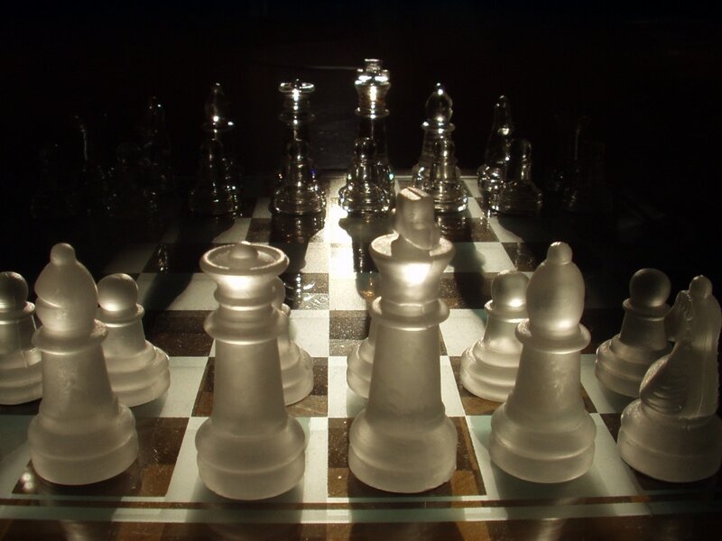 Glass chess pieces on board