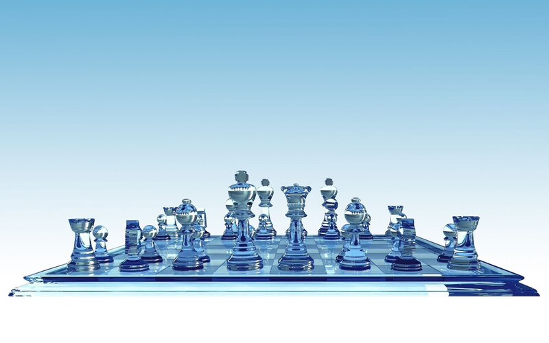 Glass chess set on blue board
