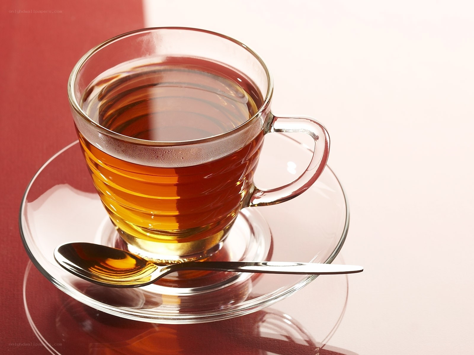 Glass cup of tea on saucer