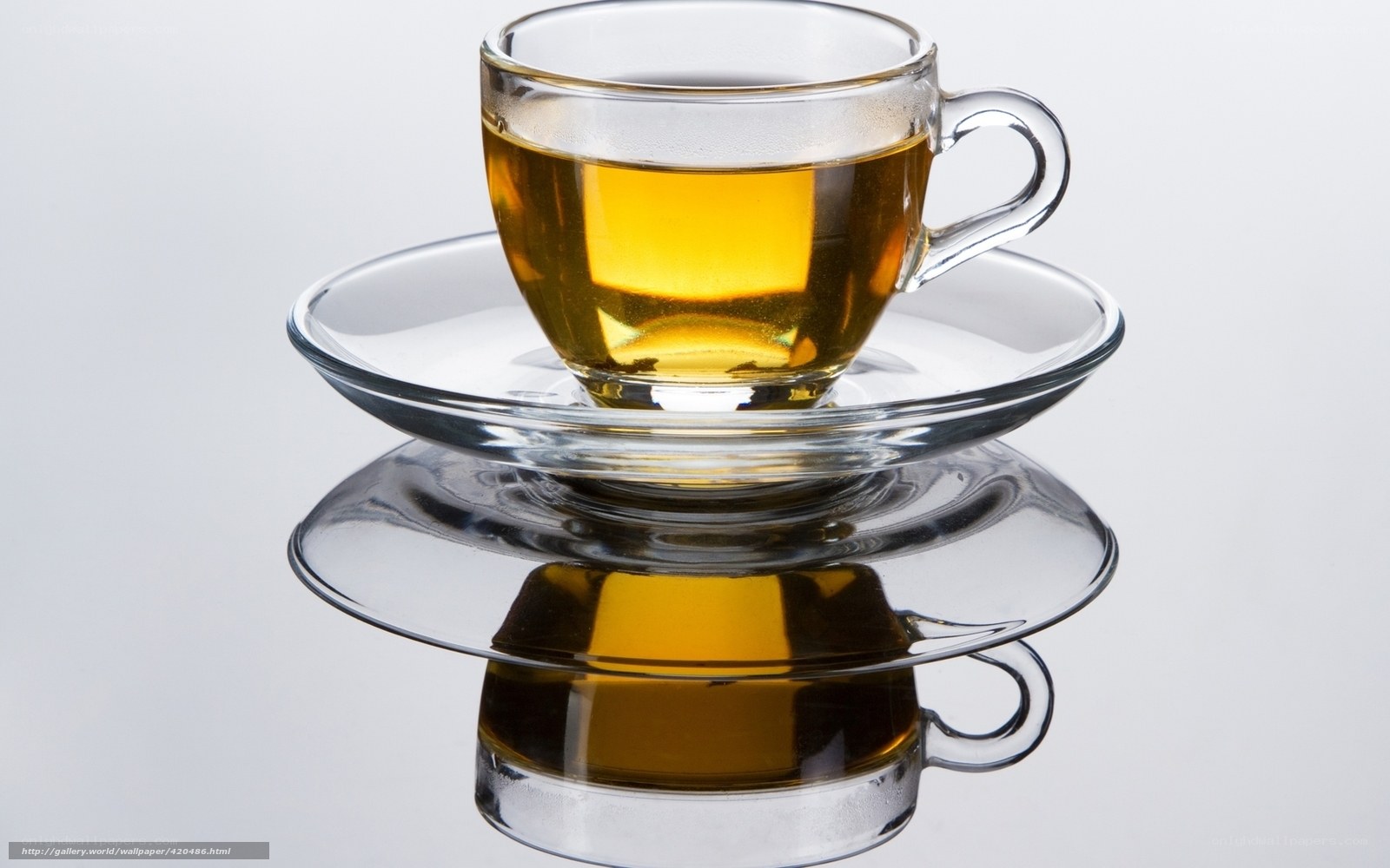 Glass cup of tea on saucer