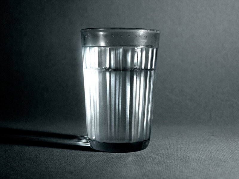 glass of water on dark surface