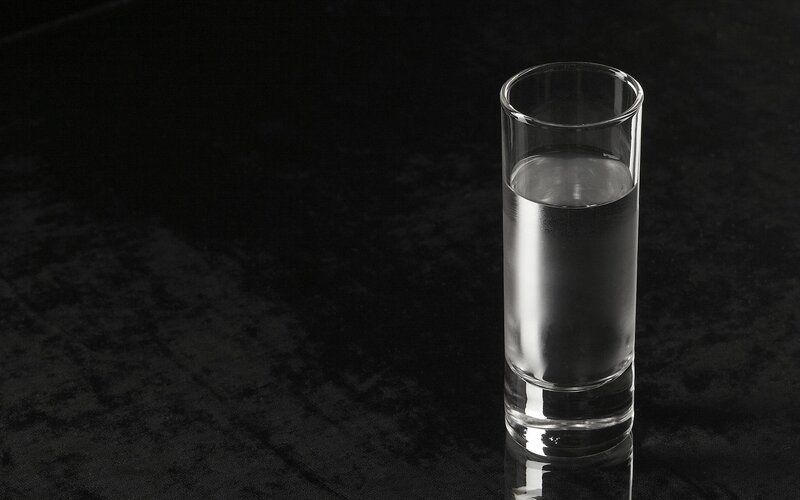 glass of water on dark surface