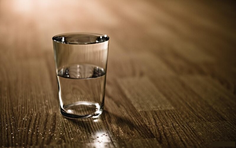 Glass of Water on Table — Brown