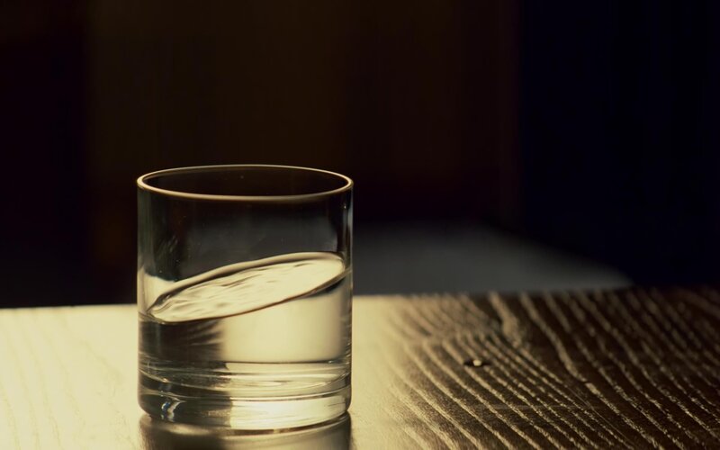 glass of water on wooden table