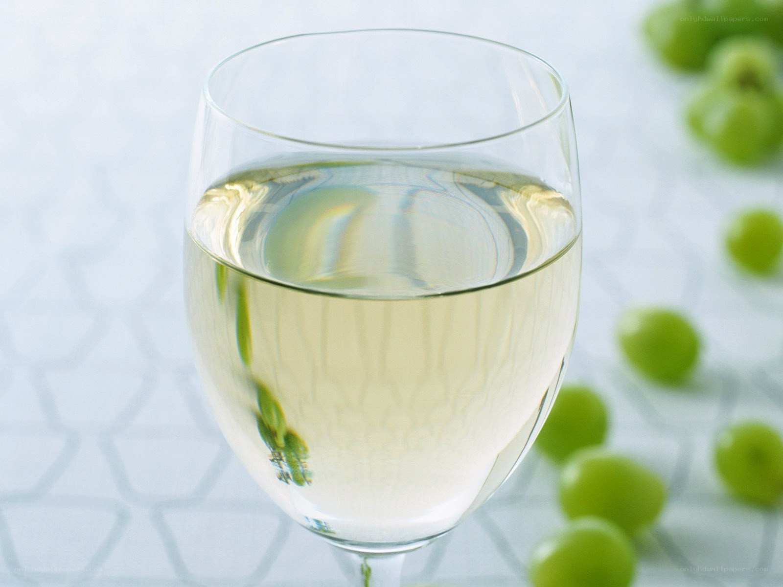 glass of white wine with grapes