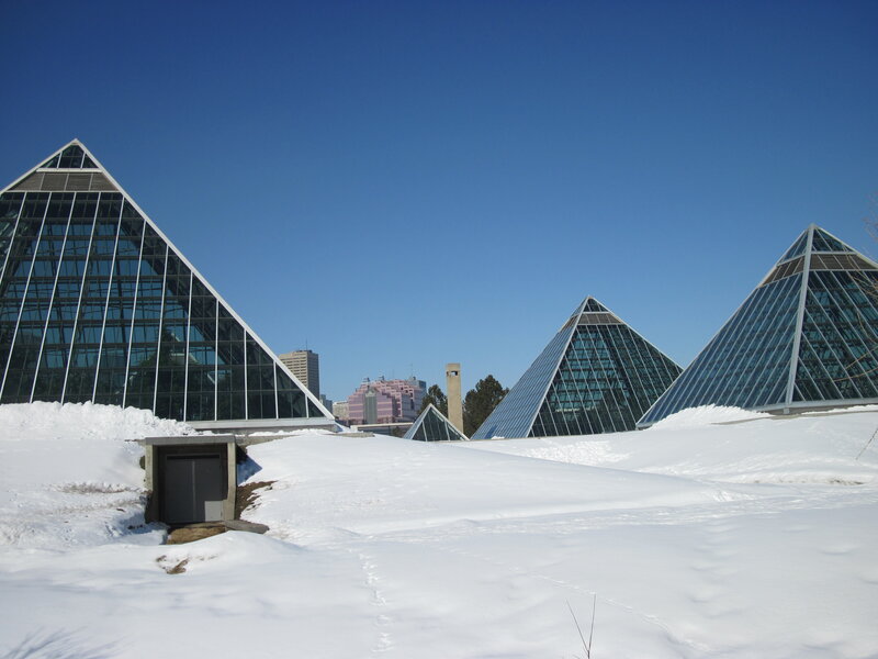 Glass Pyramids in Snow — White, Serene, Winter, Photograph, City Skyline, Pyramid Structures