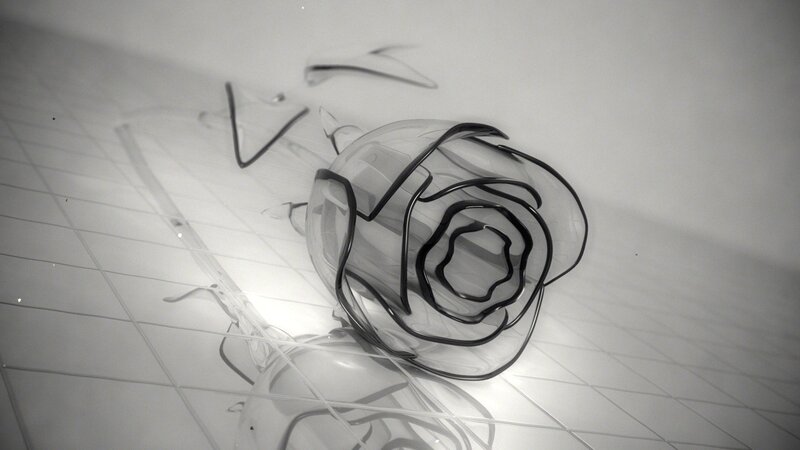 Glass rose sculpture on tiled floor