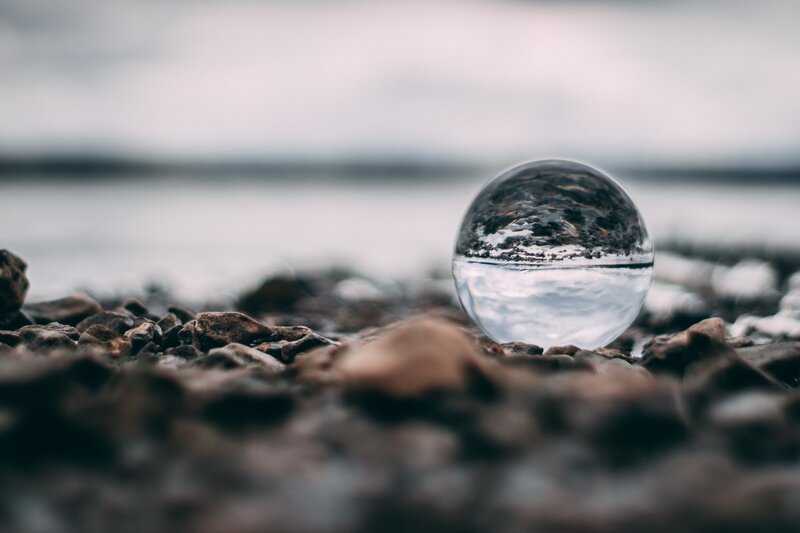 Glass Sphere on Pebbles — Gray