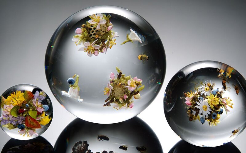 glass spheres with flowers and bees