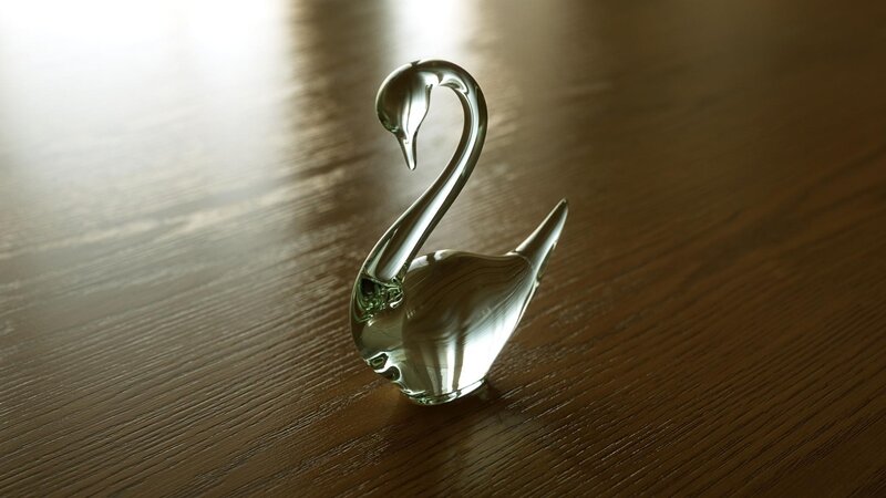 Glass swan figurine on wood