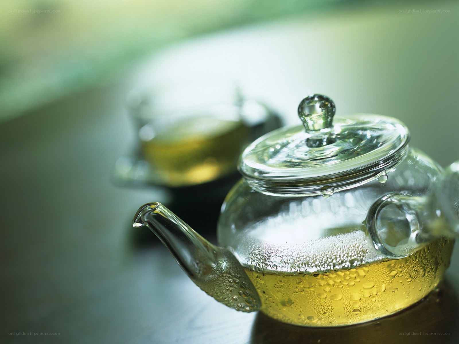 Glass teapot with green tea