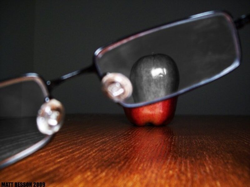 glasses and apple on wood