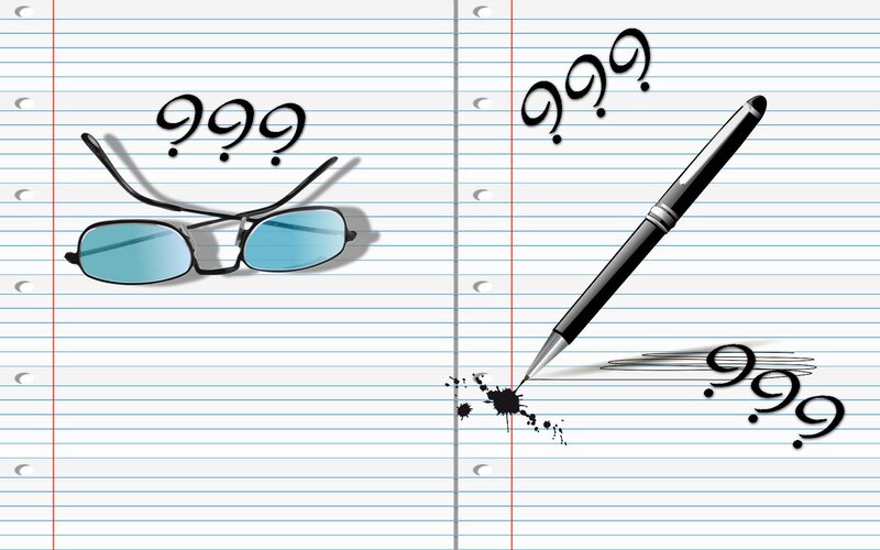 Glasses and Pen on Paper