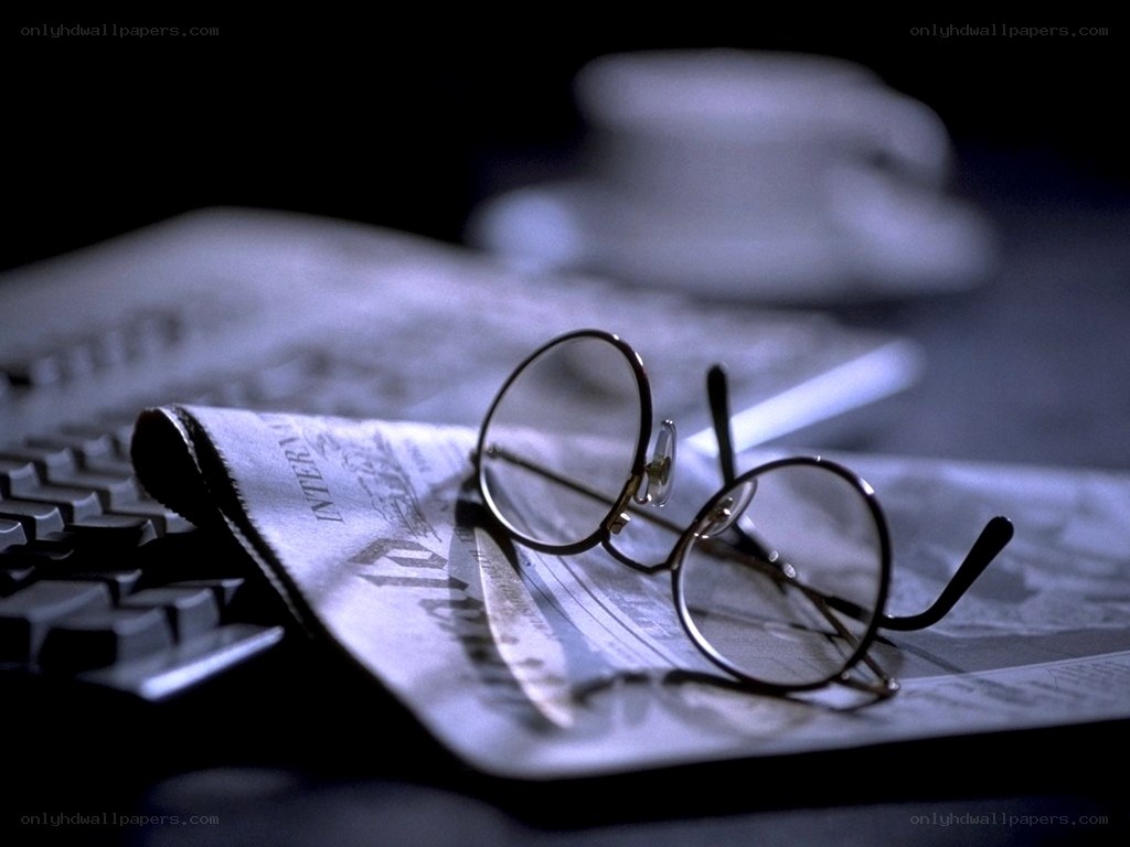 glasses on a newspaper